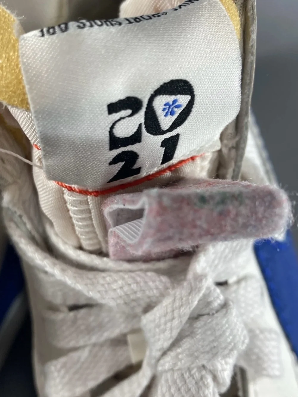 Nike Kids White High-Top Sneakers with Blue Swoosh and Red Stitching